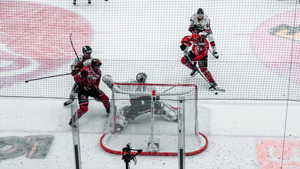 2 men playing ice hockey